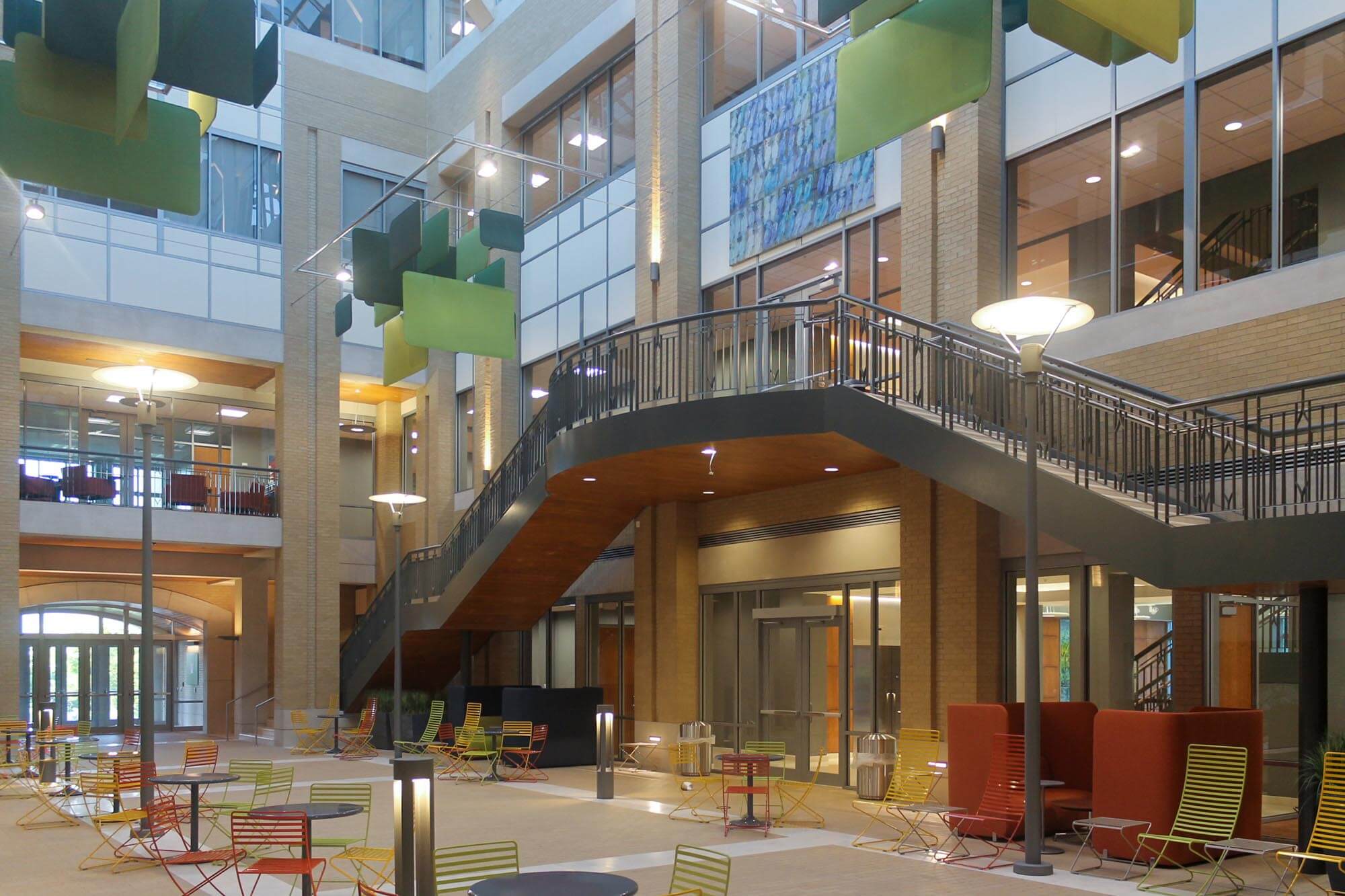 Upward view of the atrium’s green sculpture and dramatic staircases