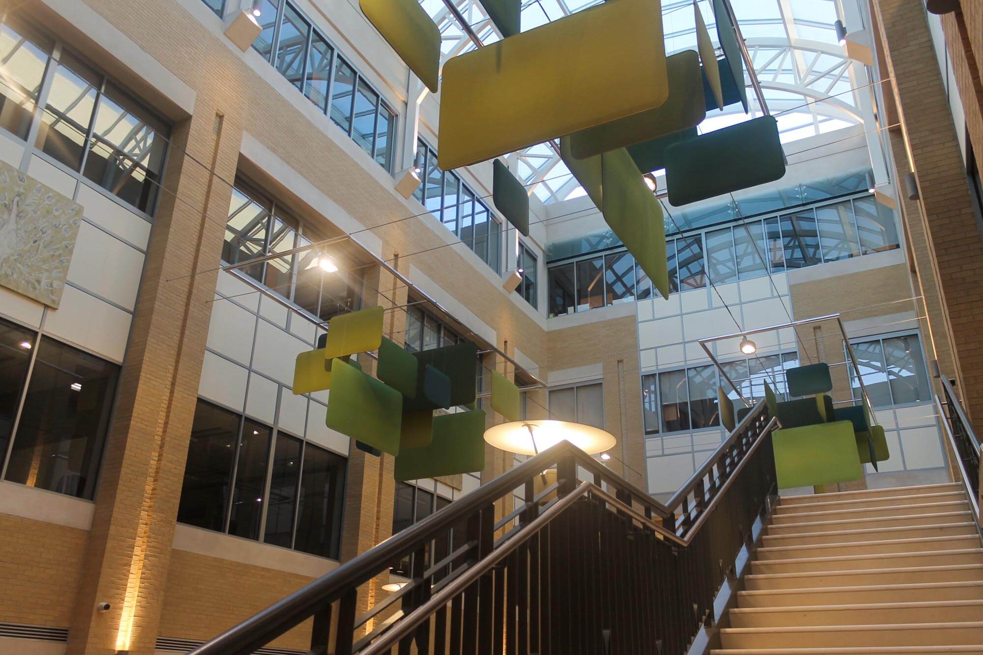 Close-up of the green geometric sculptures suspended in the atrium