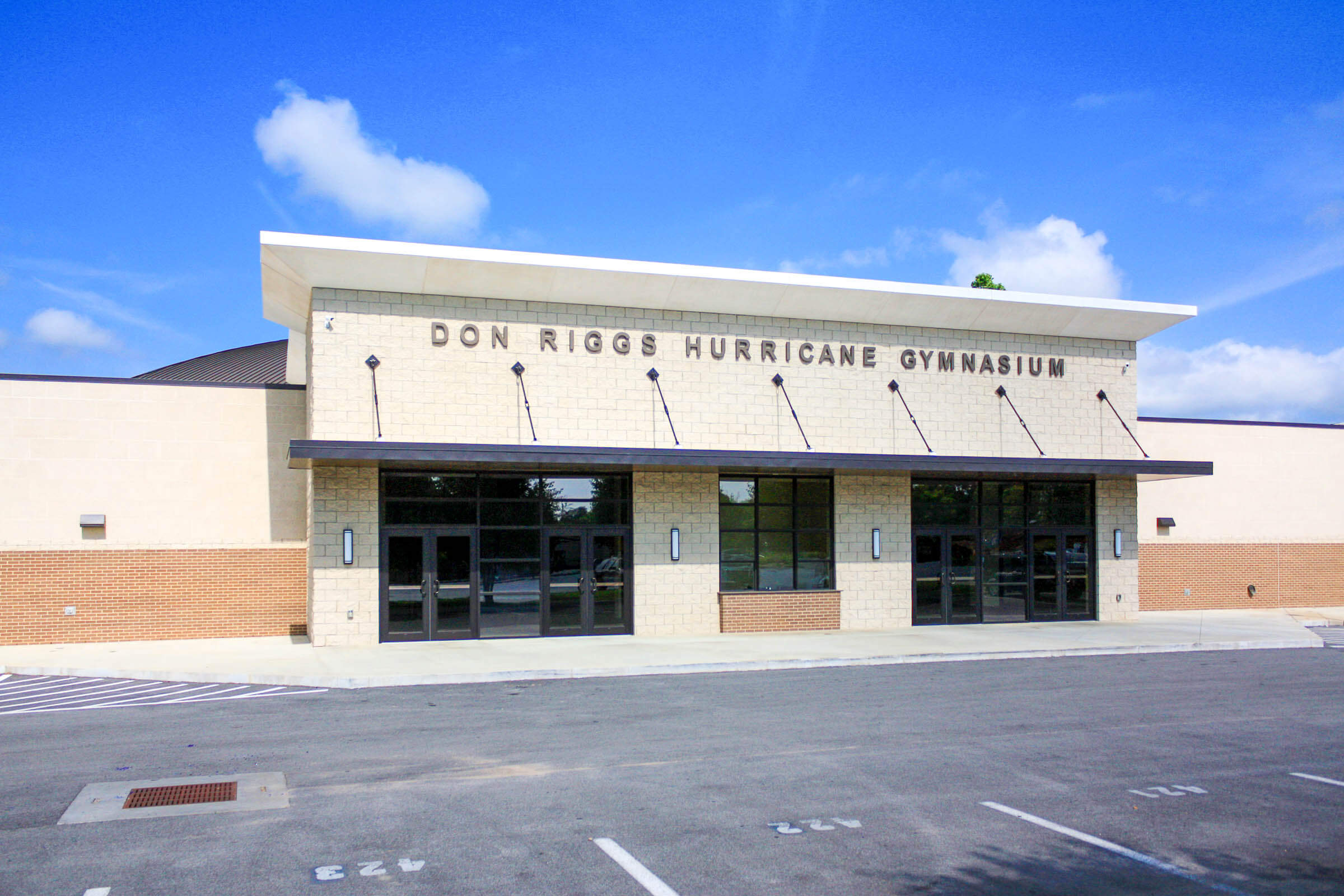 Front elevation focusing on the main entrance and Don Riggs Hurricane Gymnasium signage