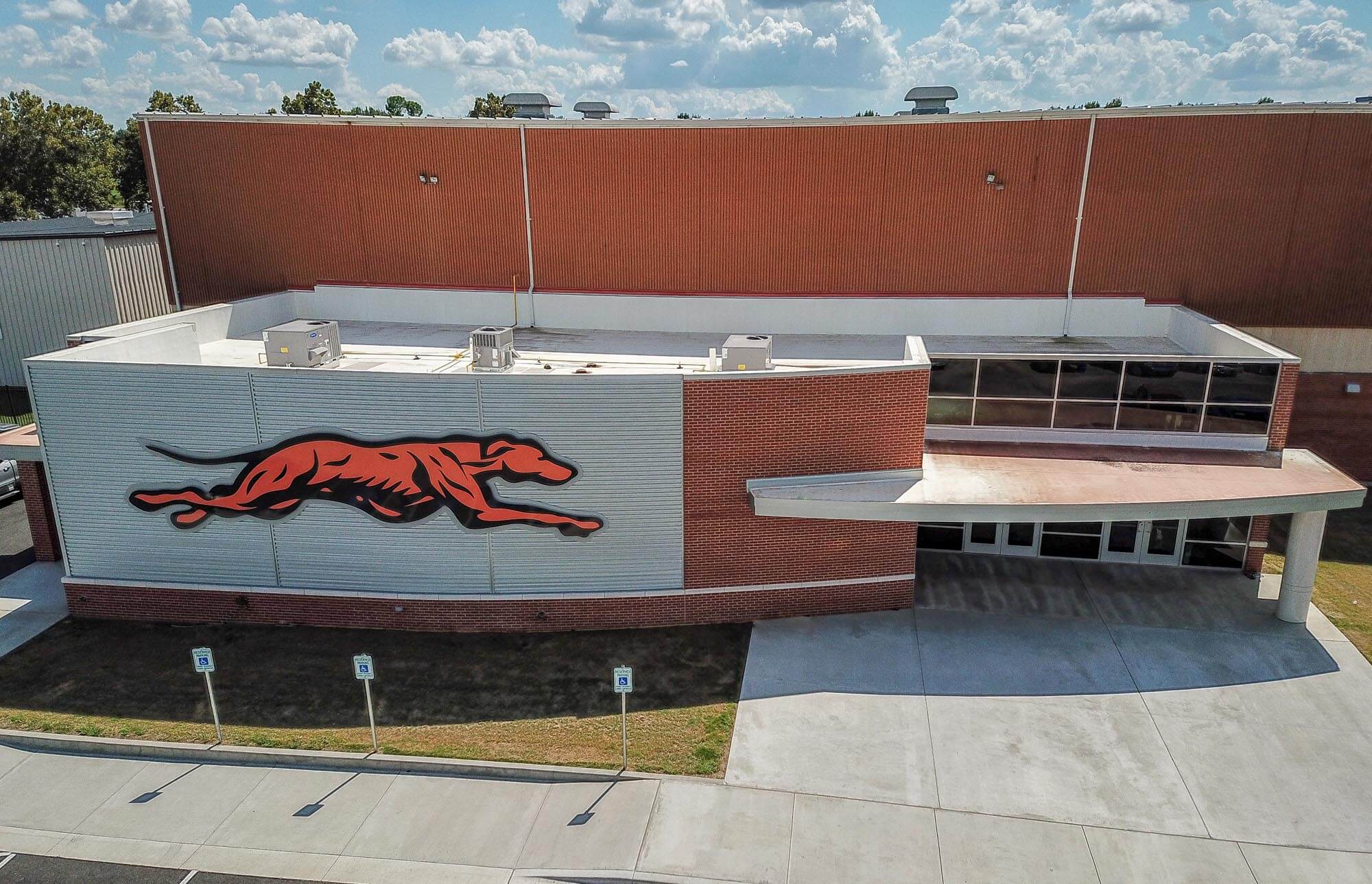 Aerial view revealing the curved brick front, and cantilevered canopy supported by a large column