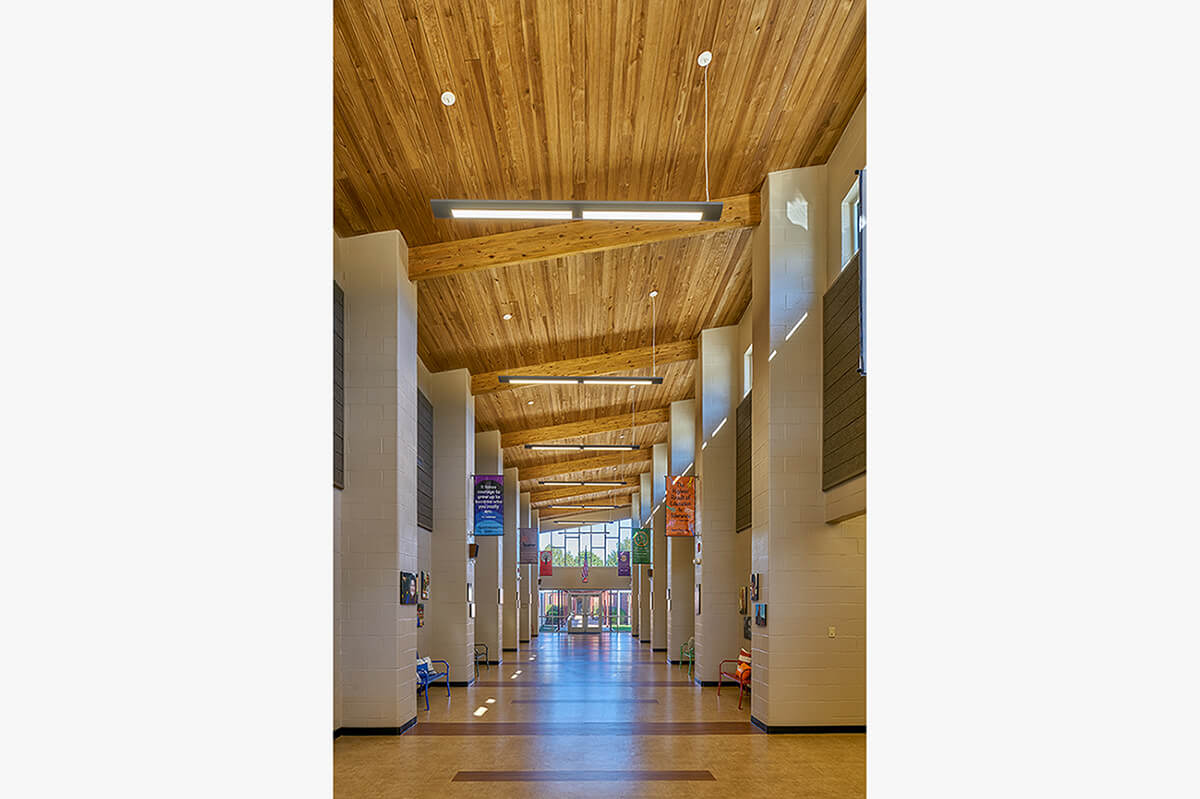 Richland Elementary hallway with wood ceiling, tall windows, and colorful banners