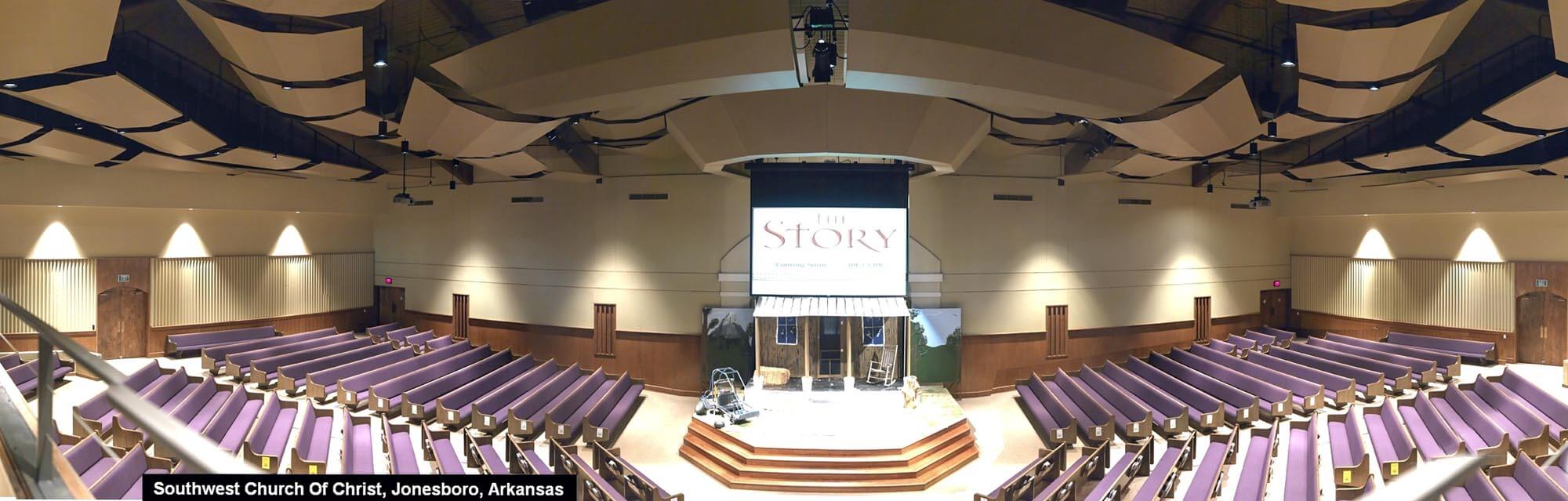 Panoramic view of renovated Southwest Church of Christ auditorium with purple pews, acoustic ceiling panels, and stage