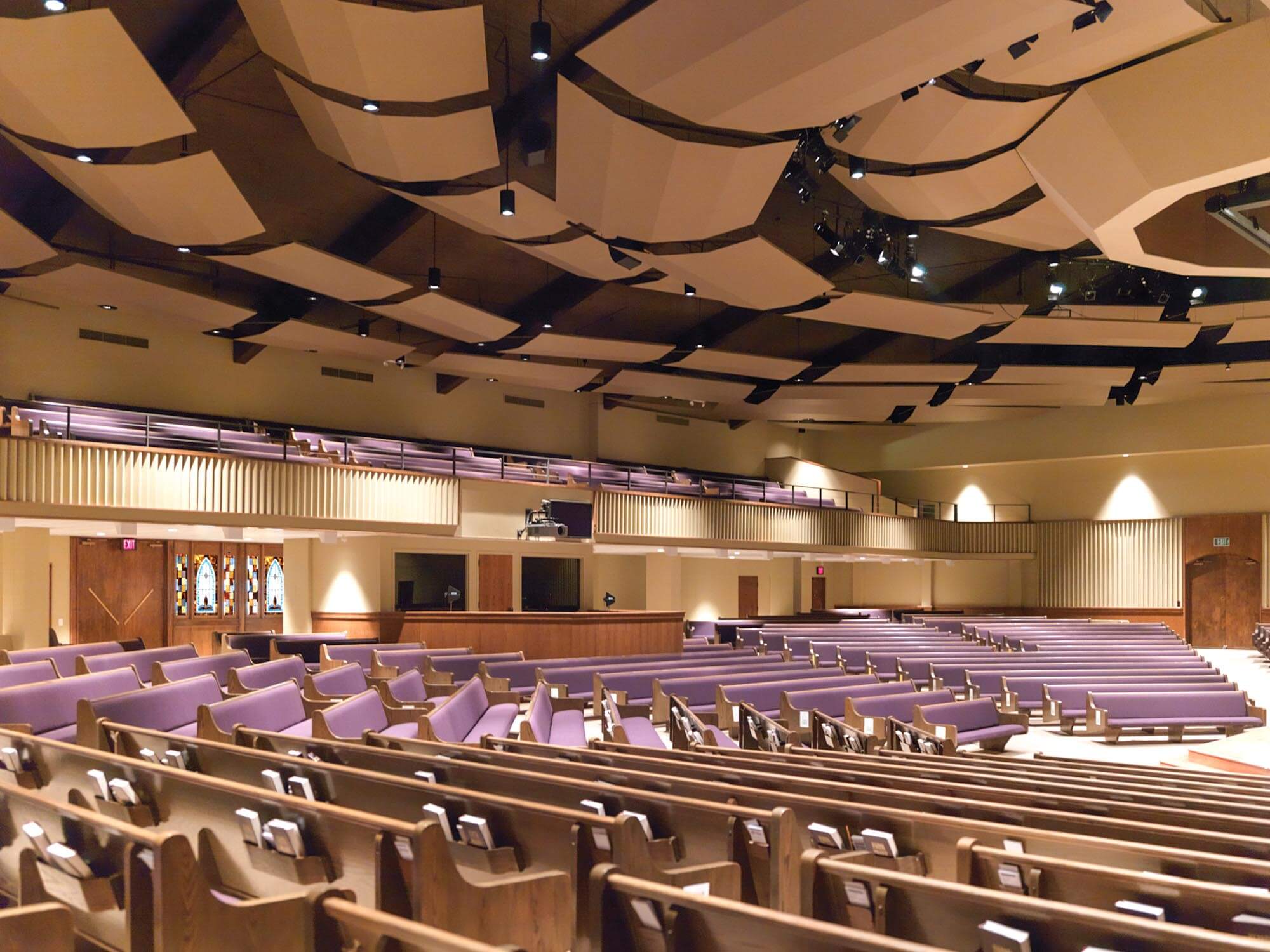 Southwest Church of Christ auditorium with purple pews and acoustic ceiling panels