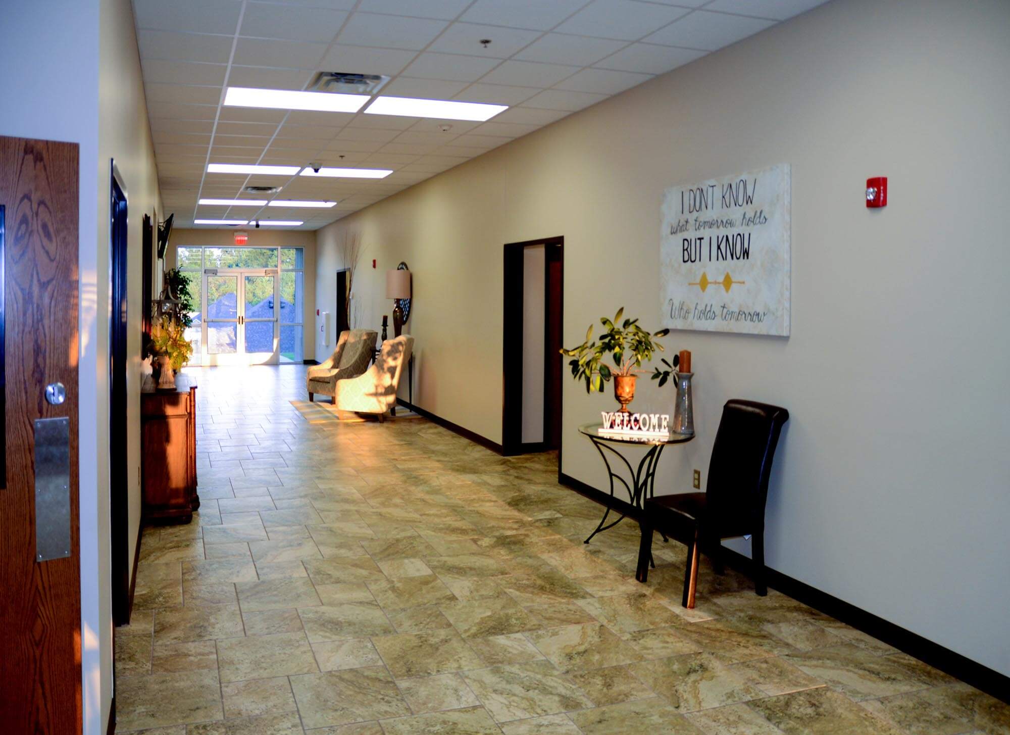 Lobby hallway of Stoneridge Church of Christ with welcome table, seating, and wall decor
