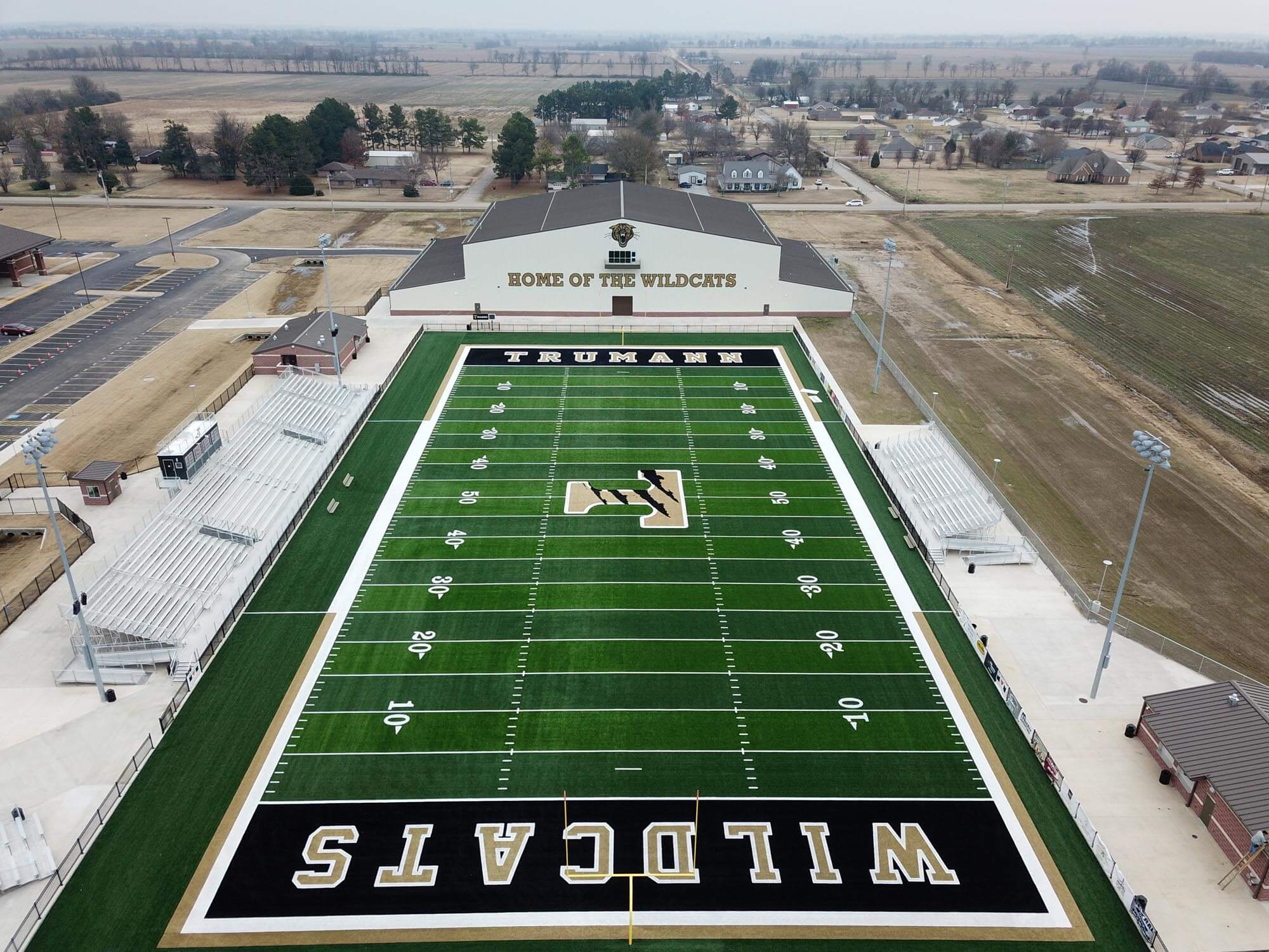 Vertical aerial of the football field showing stands, scoreboard and end zones