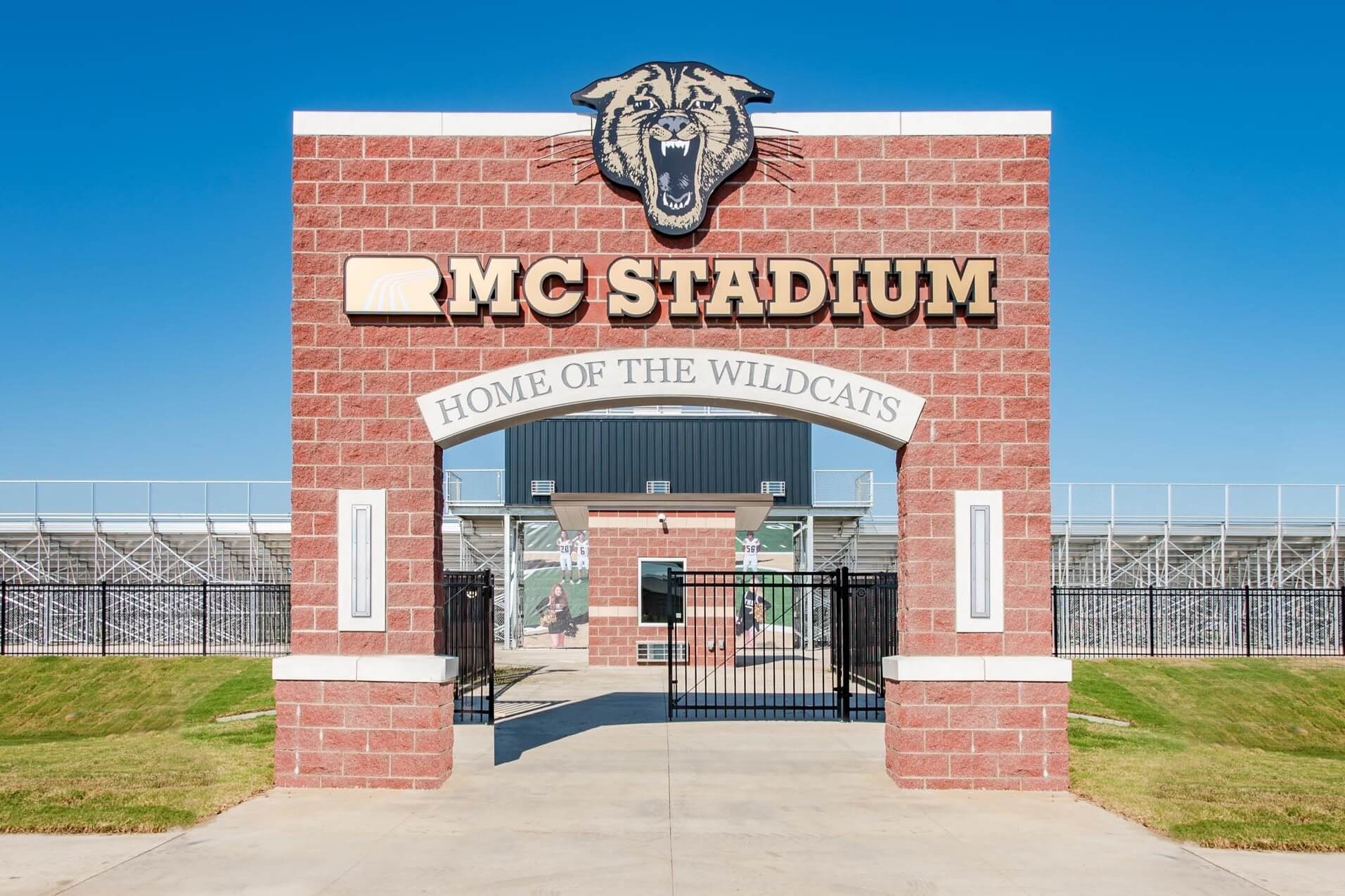 Entrance arch to RMC Stadium featuring a panther head and 'Home of the Wildcats' sign
